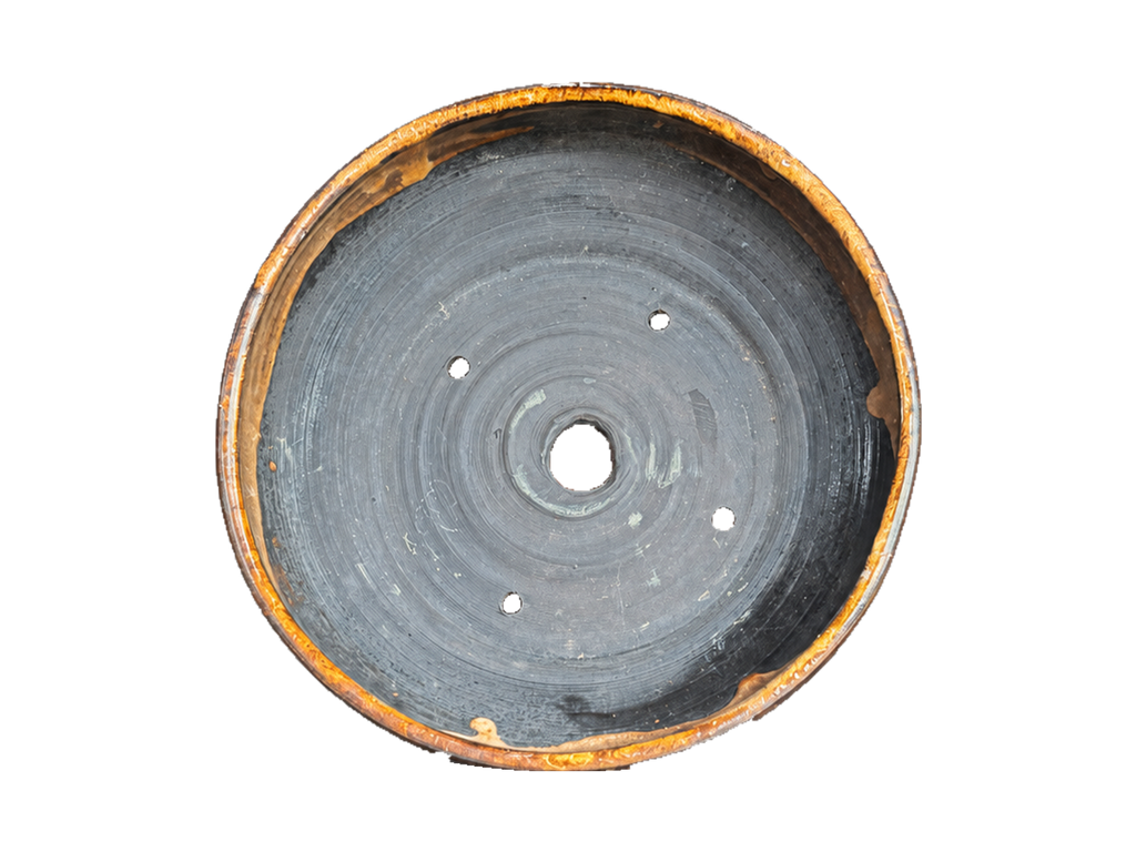 Interior of the amber and charcoal pot showing its central drainage hole and four wiring holes