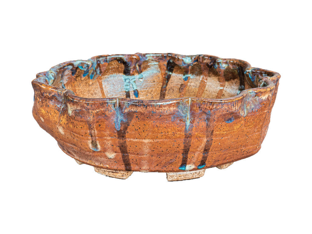 Terracotta and blue scalloped pot with dark vertical glaze streaks, turquoise drops and cream feet