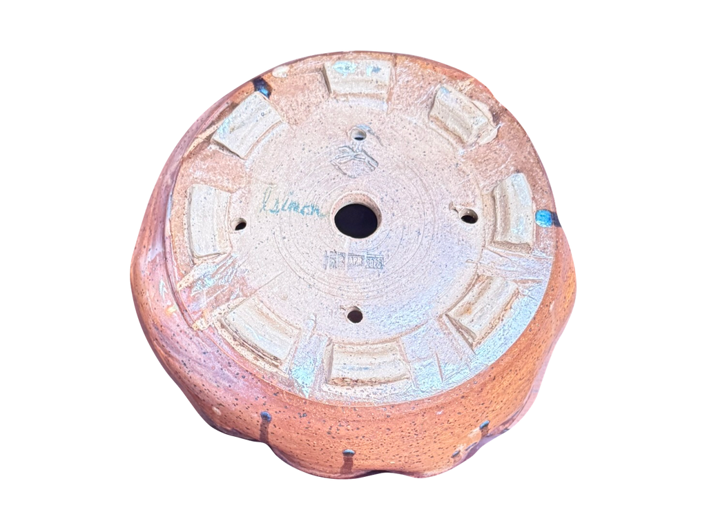 Original underside detail of the terracotta scalloped pot showing Lisa Simon's signature, date stamp, maker drawing and foot pads
